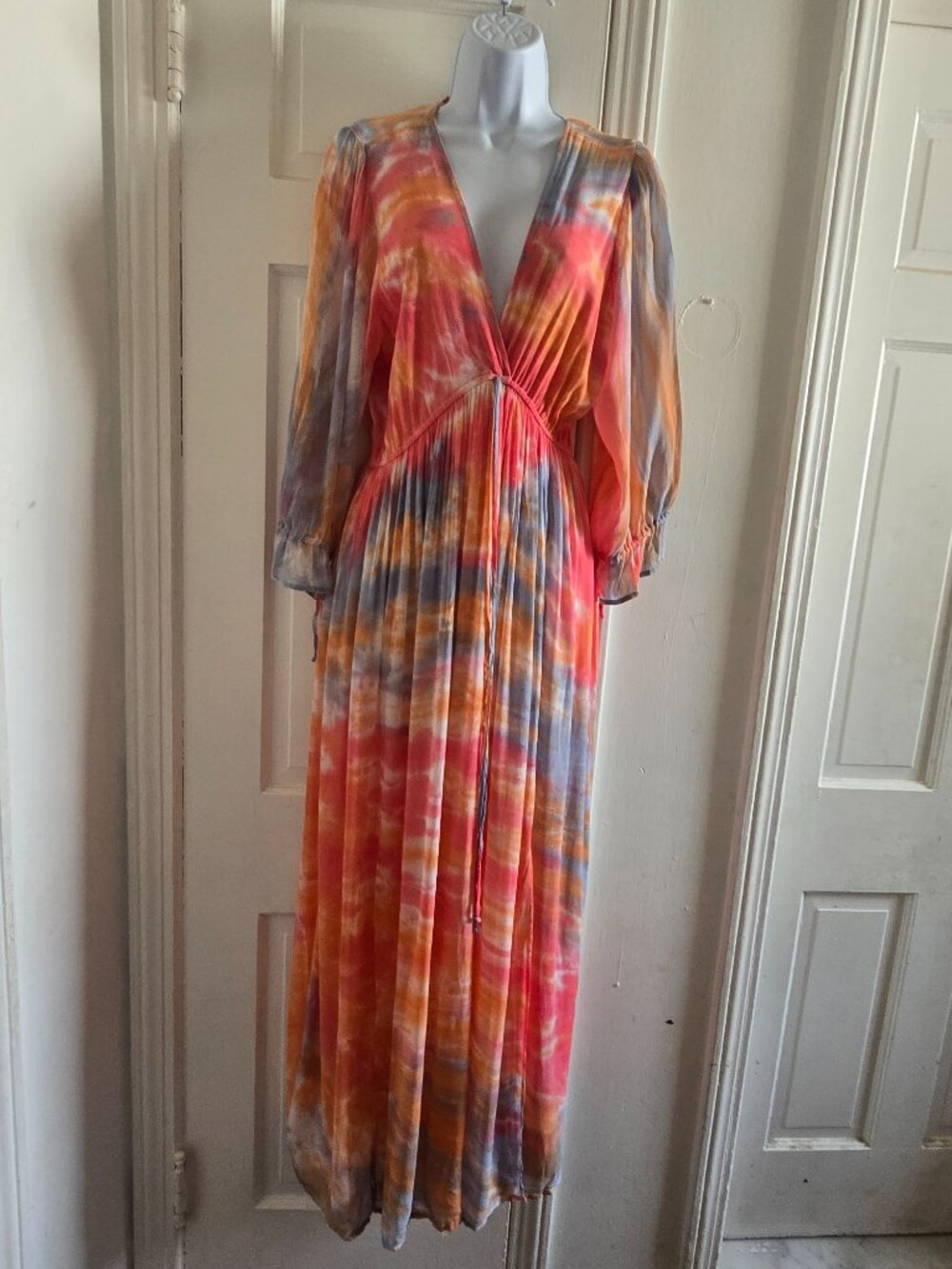 Tie Dye Maxi Dress features a deep V-neckline and Orange, Pink, and Grey color
